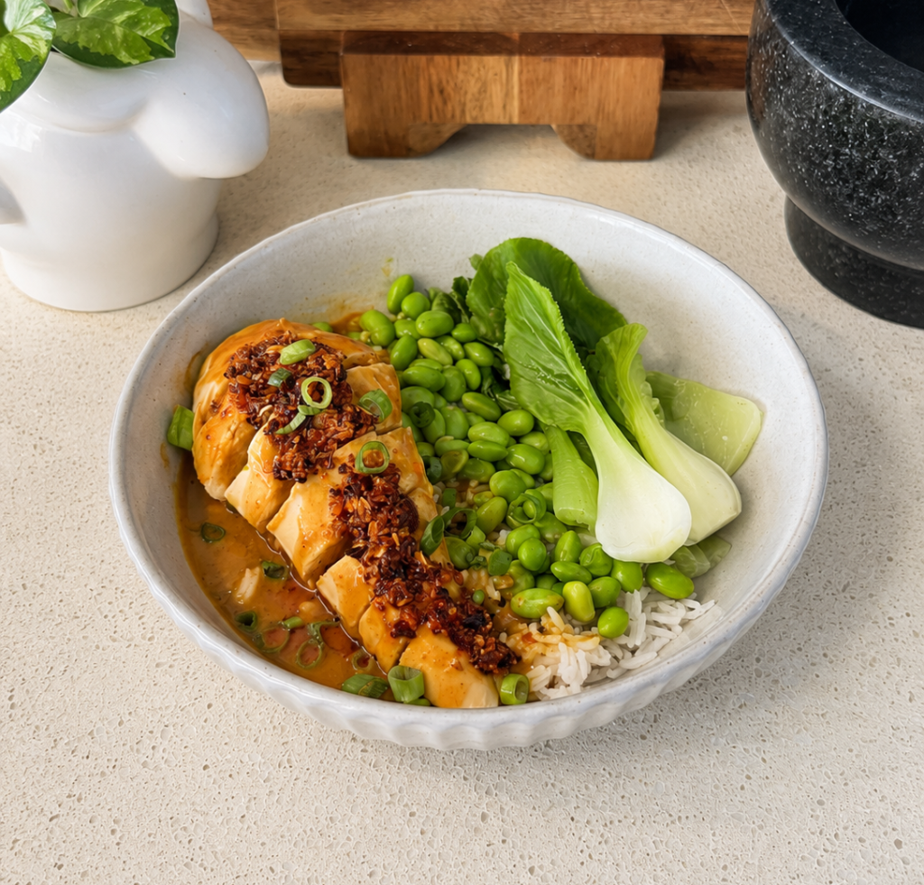 Yellow curry chicken rice bowl with bok choy, edamame and crispy chilli oil